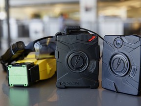 The Taser X26 smart weapon and AXON police body cameras are arranged for a photograph at the Taser International Inc. manufacturing facility in Scottsdale, Arizona, U.S., on Wednesday, April 22, 2015.