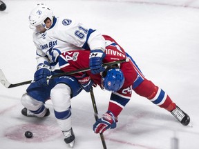 Gabriel Dumont, left, of the Tampa Bay Lightning tries to fight off Phillip Danault of the Montreal Canadiens during NHL action Friday night in Montreal. The Lightning was a 4-2 winner.