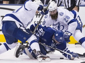 Tyler Bozak, centre, of the Toronto Maple Leafs, is caught in between Vladislav Namestnikov, left, and Luke Witkowski of the Tampa Bay Lightning during NHL action Thursday night at ACC. The Lightning defeated the Leafs 4-1 to keep their slight playoff hopes alive.
