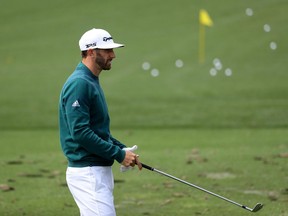 Dustin Johnson practices on the range prior to withdrawing from the Masters on April 6.