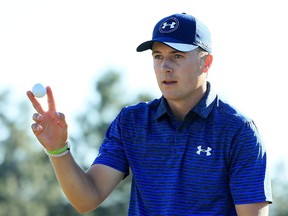 Jordan Spieth waves after making par on the 18th green during the third round of the 2017 Masters Tournament at Augusta National Golf Club on April 8, 2017.