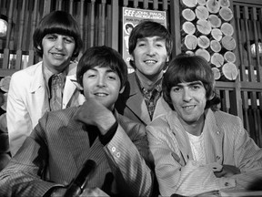 The Beatles smile before a 1966 concert in Toronto, apparently unaware that the city will ultimately destroy them.