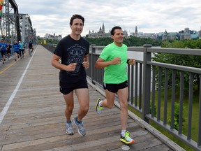 Prime Minister Justin Trudeau and Mexican President Enrique Pena Nieto run across the Alexandra Bridge from Ottawa to Gatineau, Quebec on Tuesday, June 28, 2016.