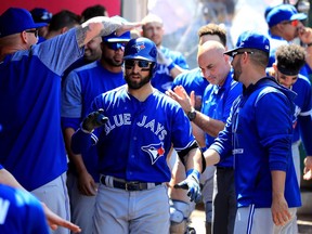 ANAHEIM, CA - APRIL 23:  Kevin Pillar #11 of the Toronto Blue Jays is congratulated in the dugout after hitting a solo homerun during the eighth inning of a game against the Los Angeles Angels of Anaheim  at Angel Stadium of Anaheim on April 23, 2017 in Anaheim, California.