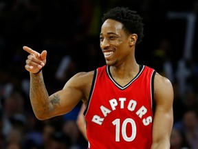 Toronto Raptors guard DeMar DeRozan points and smiles against the Detroit Pistons on April 5.