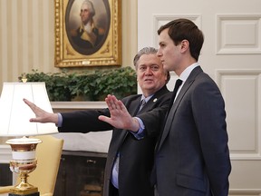 Steve Bannon, left, talks with Jared Kushner in the Oval Office of the White House in Washington, Friday, Feb. 3, 2017.