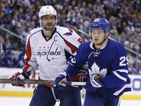 Washington Capitals forward Alex Ovechkin (left) skates against Toronto Maple Leafs forward William Nylander on April 17.