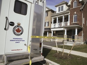 A Forensic Identification Unit vehicle located in front of a Winville Rd home in Pickering Ontario on April 8, 2017