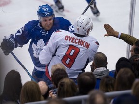 Toronto Maple Leafs forward Leo Komarov (left) checks Washington Capitals forward Alex Ovechkin on April 17.