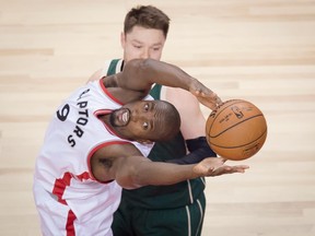 Toronto Raptors forward Serge Ibaka reaches for a loose ball against the Milwaukee Bucks on April 18.