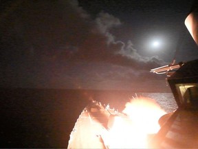 In this image provided by the U.S. Navy, the guided-missile destroyer USS Porter (DDG 78) launches a tomahawk land attack missile in the Mediterranean Sea.