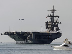 The aircraft carrier USS Carl Vinson sails out of San Diego Harbor on Aug. 22, 2014.