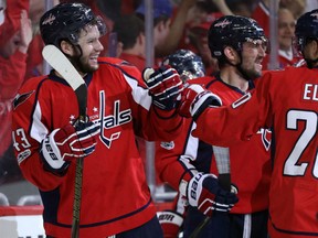 Tom Wilson, left, of the Washington Capitals, is congratulated by teammates after scoring the game-winning goal in overtime in Thursday's 3-2 victory over the Toronto Maple Leafs in Game 1 of their East Conference quarter-final series in Washington.