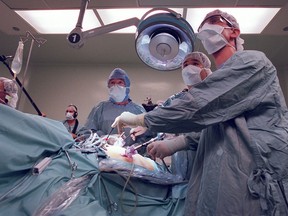 Dr. Patrick Yau, centre,   has said he conducted 6,000 gastric banding surgeries at the Slimband clinic in downtown Toronto.