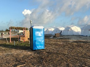 This photo provided by Jake Strang shows tents and a portable toilet set up for attendees for the Fyre Festival, Friday, April 28, 2017 in the Exuma islands, Bahamas.