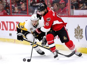 Clarke MacArthur and Olli Maatta (L) chase the puck in the third period as the Ottawa Senators take on the Pittsburgh Penguins in game 4 of the NHL Eastern Conference playoffs at the CTC.