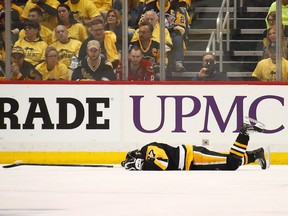 Sidney Crosby #87 of the Pittsburgh Penguins lies on the ice after taking a hit in the first period while playing the Washington Capitals  in Game Three of the Eastern Conference Second Round during the 2017 NHL Stanley Cup Playoffs at PPG Paints Arena on May 1, 2017 in Pittsburgh, Pennsylvania.