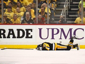 In this May 1 file photo, Sidney Crosby lies on the ice after being hit by Washington Capitals defenceman Matt Niskanen.
