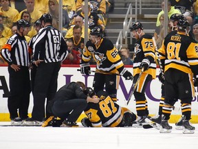 Sidney Crosby #87 of the Pittsburgh Penguins lies on the ice after taking a hit in the first period while playing the Washington Capitals  in Game Three of the Eastern Conference Second Round during the 2017 NHL Stanley Cup Playoffs at PPG Paints Arena on May 1, 2017 in Pittsburgh, Pennsylvania.