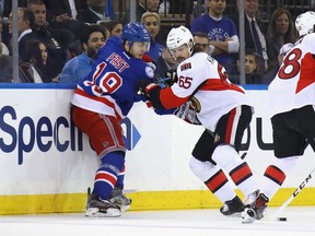 Jesper Fast of the New York Rangers battles with Erik Karlsson of the Ottawa Senators during the first period in Game Four of the Eastern Conference Second Round during the 2017 NHL Stanley Cup Playoffs at Madison Square Garden on May 4, 2017 in New York City.