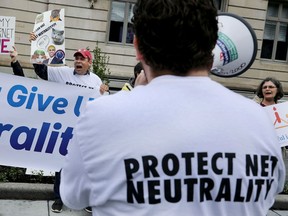 Proponents of net neutrality protest against Federal Communication Commission Chairman Ajit Pai outside the American Enterprise Institute