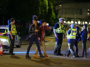 Police and fans close to the Manchester Arena on May 23, 2017 in Manchester, England.