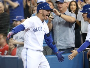 Josh Donaldson of the Blue Jays celebrates after hitting a two-run homer in the fourth inning against the Cincinnati Reds at Rogers Centre in Toronto on Tuesday night.