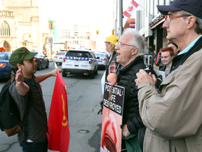 A pro-choice demonstrator, left, confronts pro-life demonstrators in front of Ottawa’s Morgentaler Clinic in April.