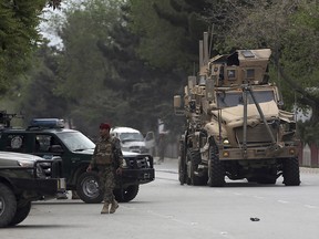 A damaged US military vehicle is being pulled near the site of a suicide attack in Kabul, Afghanistan, Wednesday, May 3 , 2017.