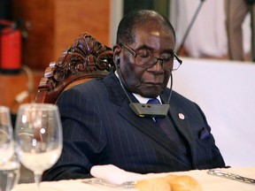 This file photo taken on January 13, 2017 shows Zimbabwe President Robert Mugabe (R) attending a State Dinner for the Africa-France Summit with the Rwandan president in Bamako on January 13, 2017