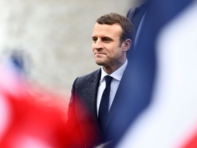French flags flutter as President Emmanuel Macron arrives to lay a wreath of flower on the unknown Soldier's tomb at the Arc of Triomphe monument after his formal inauguration