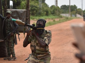 A mutinous soldier holds a RPG rocket launcher inside a military camp in the Ivory Coast's central second city Bouake, on May 15, 2017
