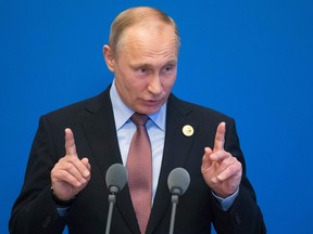 Russian President Vladimir Putin gestures while speaking to the media on May 15, 2017.