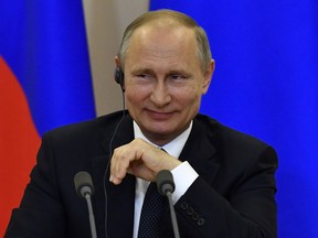 Russian President Vladimir Putin smiles during a press conference on May 17, 2017