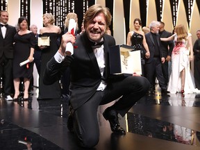 Swedish director Ruben Ostlund poses on stage with his trophy after he won the Palme d'Or for his film 'The Square' on May 28, 2017 during the closing ceremony of the 70th edition of the Cannes Film Festival in Cannes, southern France.