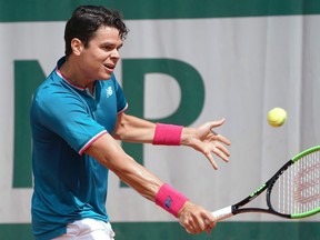 Canada's Milos Raonic returns the ball to Belgium's Steve Darcis during their tennis match at the Roland Garros 2017 French Open on May 29, 2017 in Paris.