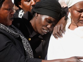 Akon Guode, 35, at the funeral of her 3 children Bol, Anger and Madit who were tragically killed when she veered off the road into a lake, at St Andrews Catholic Church on April 18, 2015.