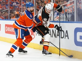 Edmonton Oilers defenceman Adam Larsson (left) checks Anaheim Ducks forward Corey Perry on May 3.