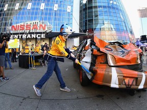 A Nashville Predators fan hits an Anaheim Ducks car with a sledgehammer at Nashville's Bridgestone Arena on May 18.