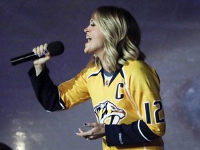 Carrie Underwood performs the national anthem before Game 3 of a first-round NHL hockey playoff series between the Predators and the Chicago Blackhawks in Nashville, Tenn.