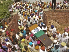 Relatives and friends carry the coffin of Indian soldier Naib Subedar Paramjit Singh on Tuesday, May 2, 2017. Two Indian soldiers were killed and their bodies mutilated Monday in an ambush by Pakistani soldiers along the highly militarized de facto border that divides the disputed region of Kashmir between the nuclear-armed rivals, the Indian army said. But Pakistan denied any such attack, calling the Indian claims false.