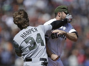 Washington Nationals' Bryce Harper (34) hits San Francisco Giants' Hunter Strickland in the face after being hit with a pitch in the eighth inning of a baseball game Monday, May 29, 2017, in San Francisco.