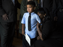 Natasha De Alencar holds her son Marcos, 4, as his father's casket is wheeled out of a church Tuesday in Abingdon, Maryland. Staff Sgt. Mark R. DeAlencar was killed on April 8 in Nangarhar province, Afghanistan, when his unit clashed with enemy forces. 