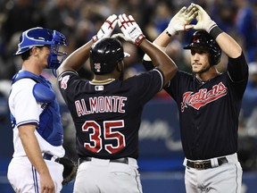 Cleveland Indians catcher Yan Gomes is congratulated by teammate Abraham Almonte after hitting a three-run homer against the Blue Jays during eighth inning action in Toronto on Tuesday night.