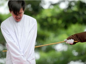 One of two Indonesian men is publicly caned for having sex, in a first for the Muslim-majority country where there are concerns over mounting hostility towards the small gay community, in Banda Aceh.