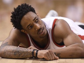 Toronto Raptors guard DeMar DeRozan lies on the floor after committing a foul against the Cleveland Cavaliers on May 7.