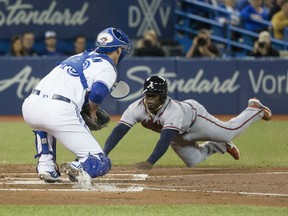 Adonis Garcia of the Atlanta Braves beats the throw to Toronto Blue Jays' catcher Mike Ohlman during MLB action Monday night at Rogers Centre. The Braves were 10-6 winners, ending the Jays winning streak at five games.