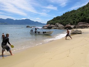 Men play paddle ball on one of the many beaches of Ilha Grande, Brazil.
