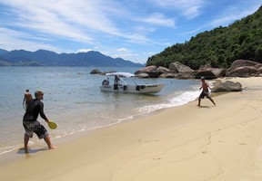 Men play paddle ball on one of the many beaches of Ilha Grande, Brazil.