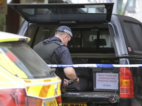 A bomb squad officer attends the scene as police evacuate the Arndale shopping centre, in Manchester, England